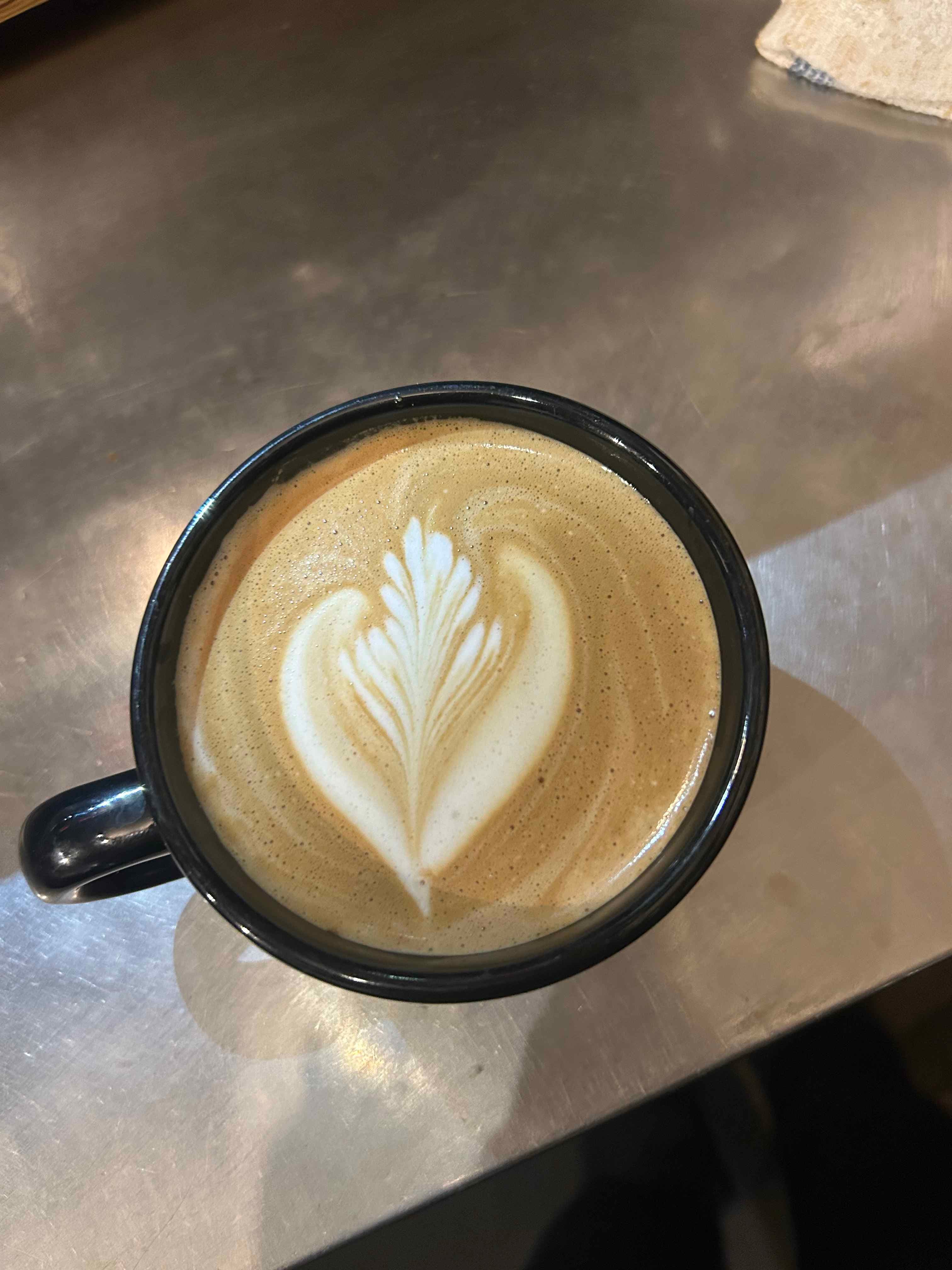 Latte with a symmetrical rosetta in the foam